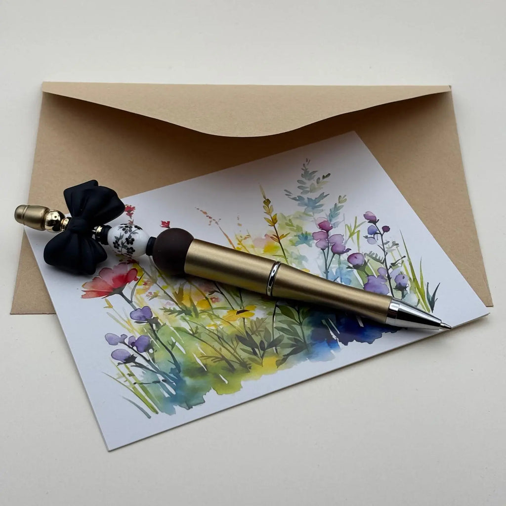 Stylo doré à bille noir avec mine rétractable par rotation avec perles en porcelaine blanche et en verre