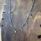 Collier argenté | Breloques fleurs lune étoile et soleil vue de près  | Acier inoxydable