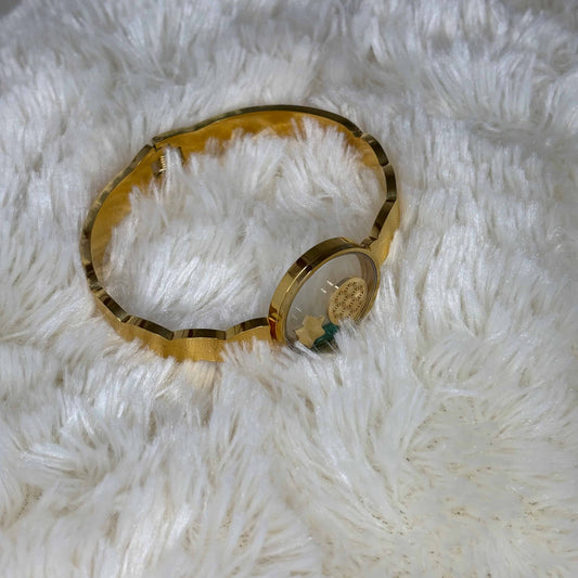 Bracelet doré |A jonc ouvert |Cercle central transparent avec éléments décoratifs | Ouverture par le dessous |Acier inoxydable