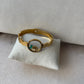 Bracelet doré |A jonc ouvert |Cercle central transparent avec éléments décoratifs | Acier inoxydable