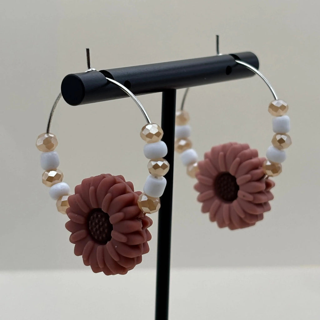 Des boucles d'oreilles créole avec perles et fleur rose