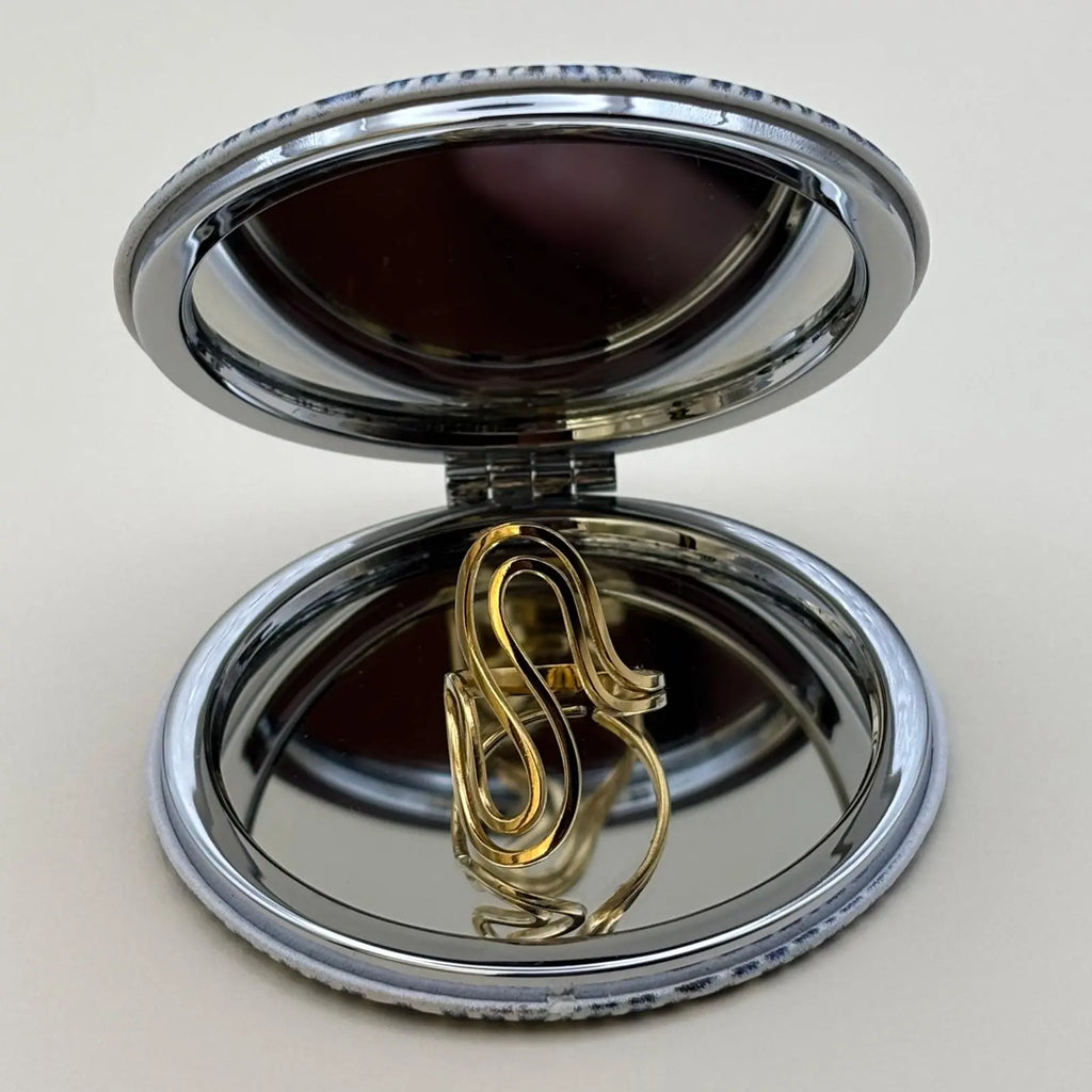 Bague dorée réglable avec des formes de volutes