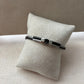 Bracelet argenté homme | Câble tressé noir acier inoxydable | Détail central rose des vents