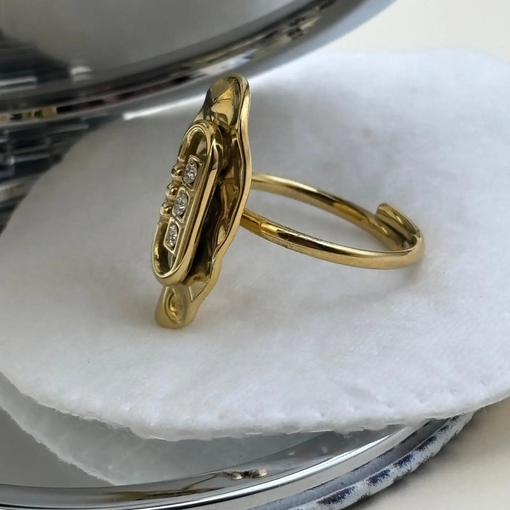 Bague dorée ajustable ovale avec trois brillants alignés dans une forme géométrique