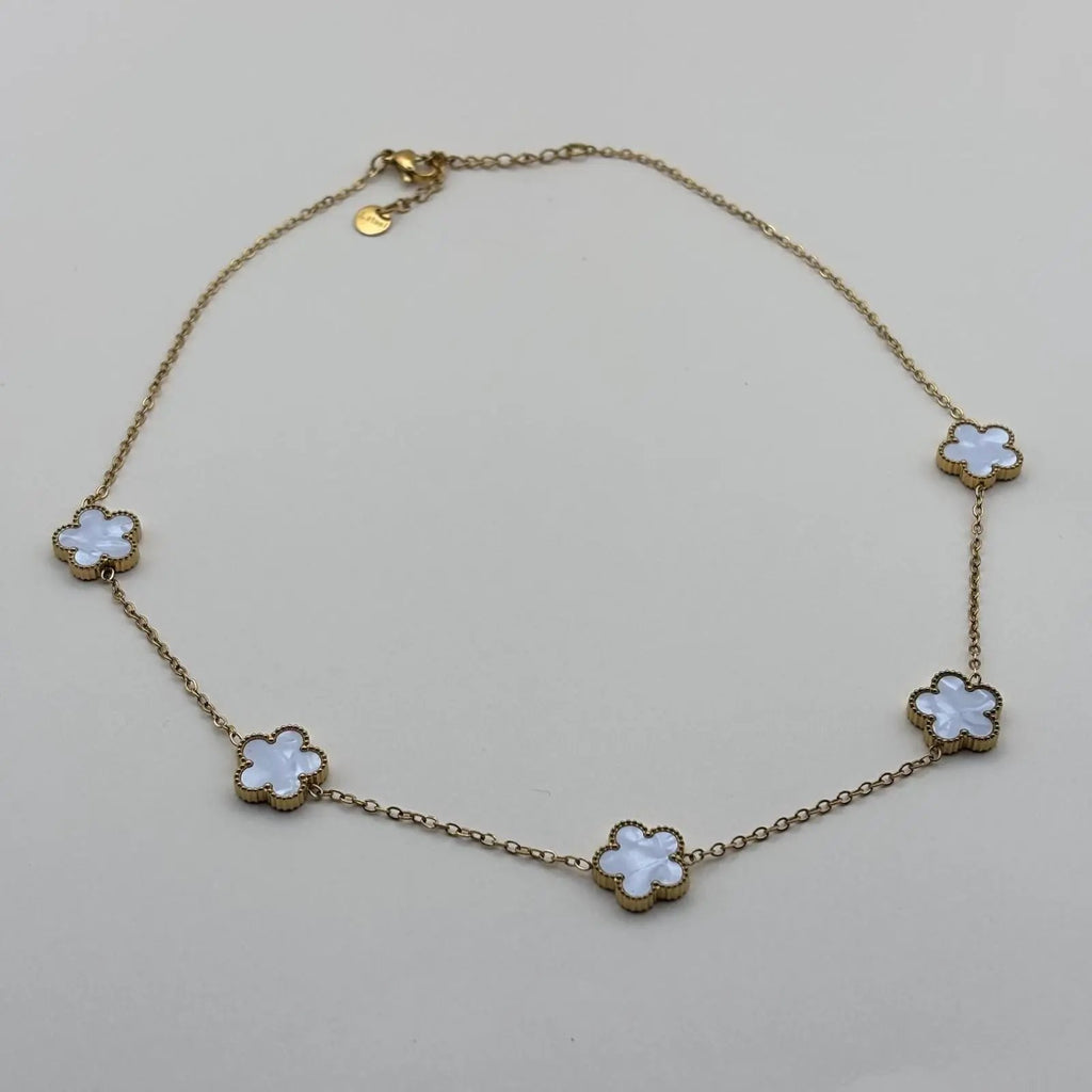 Collier doré avec de fins maillons et des fleurs colorées blanches en acier inoxydable
