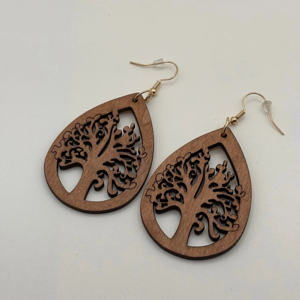 Des boucles d'oreilles avec attache dorée et boucle en bois motif arbre de vie