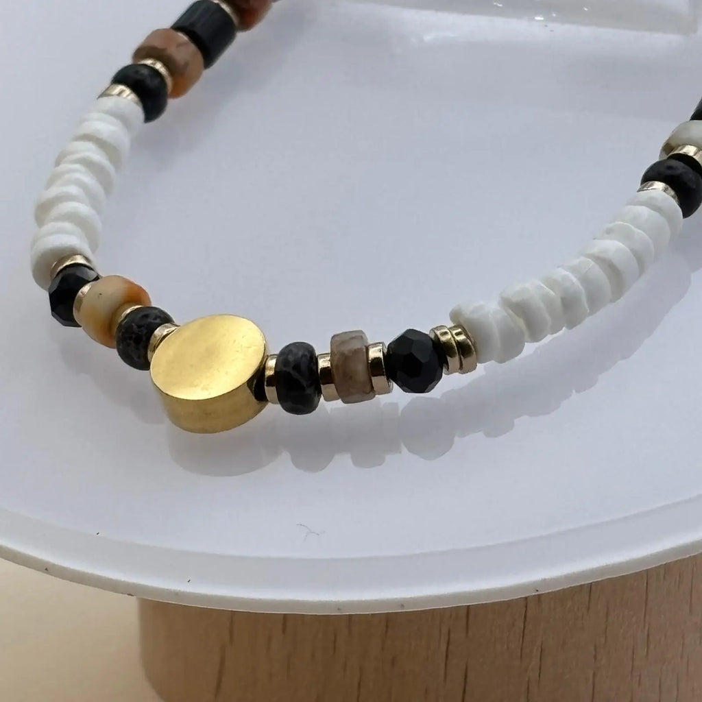 Bracelet artisanal en perles rondes et plates et une breloque cercle doré