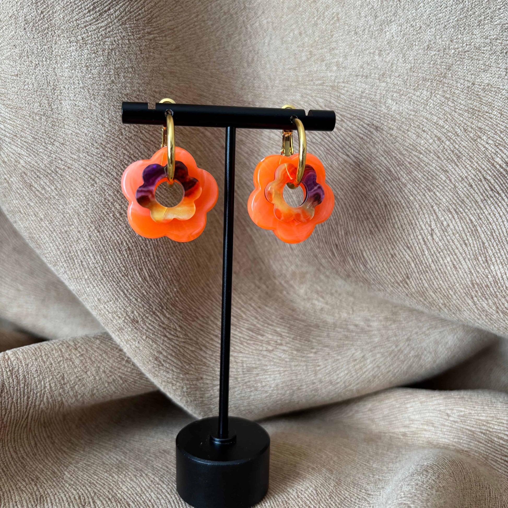 Petites boucles d'oreilles créoles dorées avec fleur couleur orange vendues sur le site internet prêtes à briller