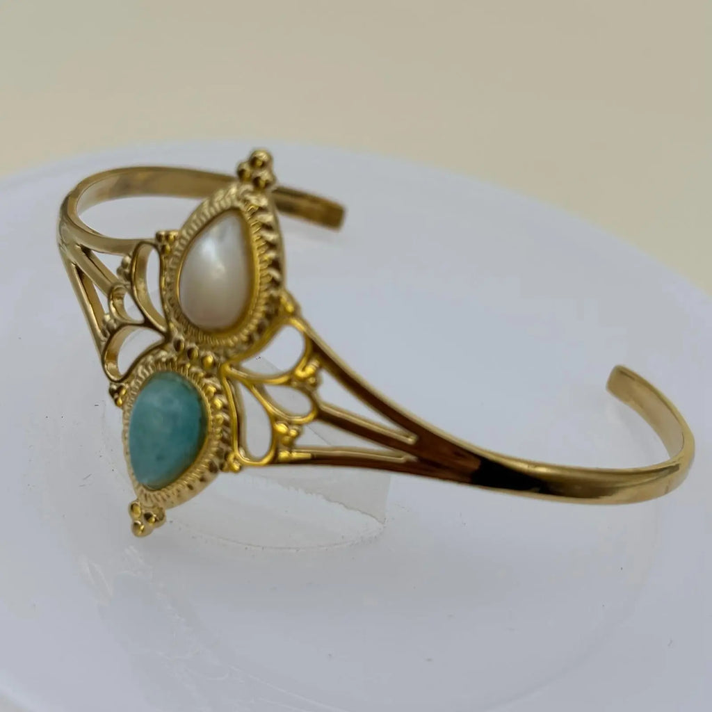Bracelet doré rigide ouvert en acier inoxydable avec deux pierres blanche et turquoise