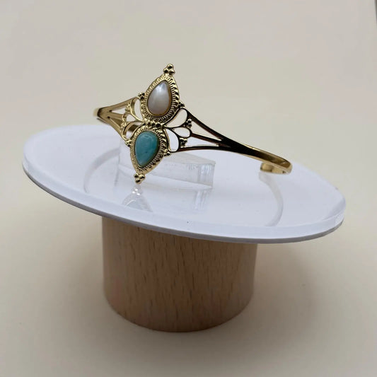 Bracelet doré rigide ouvert en acier inoxydable avec deux pierres blanche et turquoise