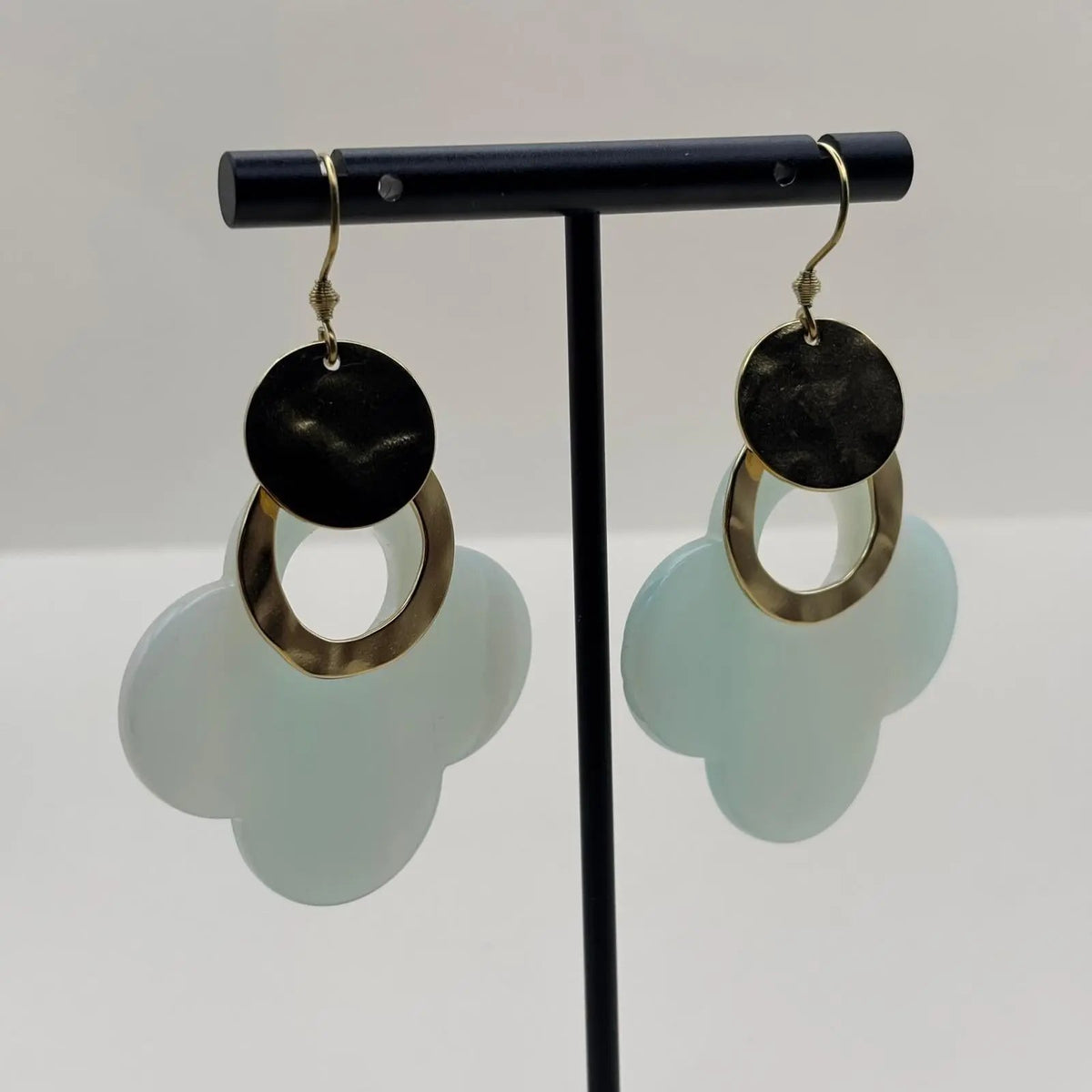 Des boucles d'oreilles dorées avec fleur stylisée en résine turquoise et anneaux dorés