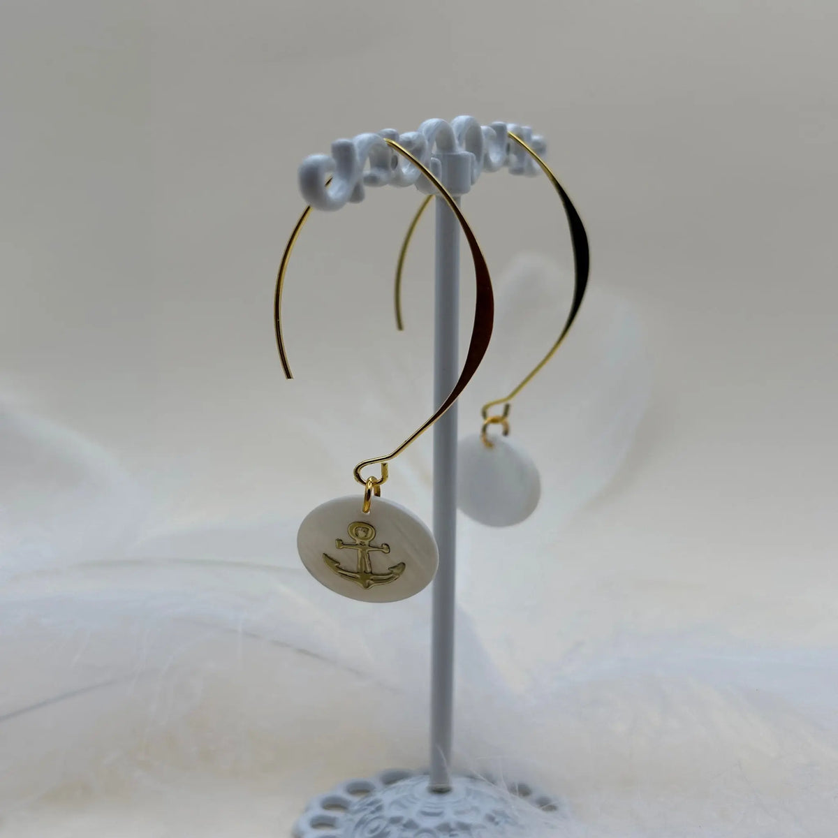 Paire de boucles d'oreilles pendentif avec une pastille nacrée et dessin d'une ancre de marine