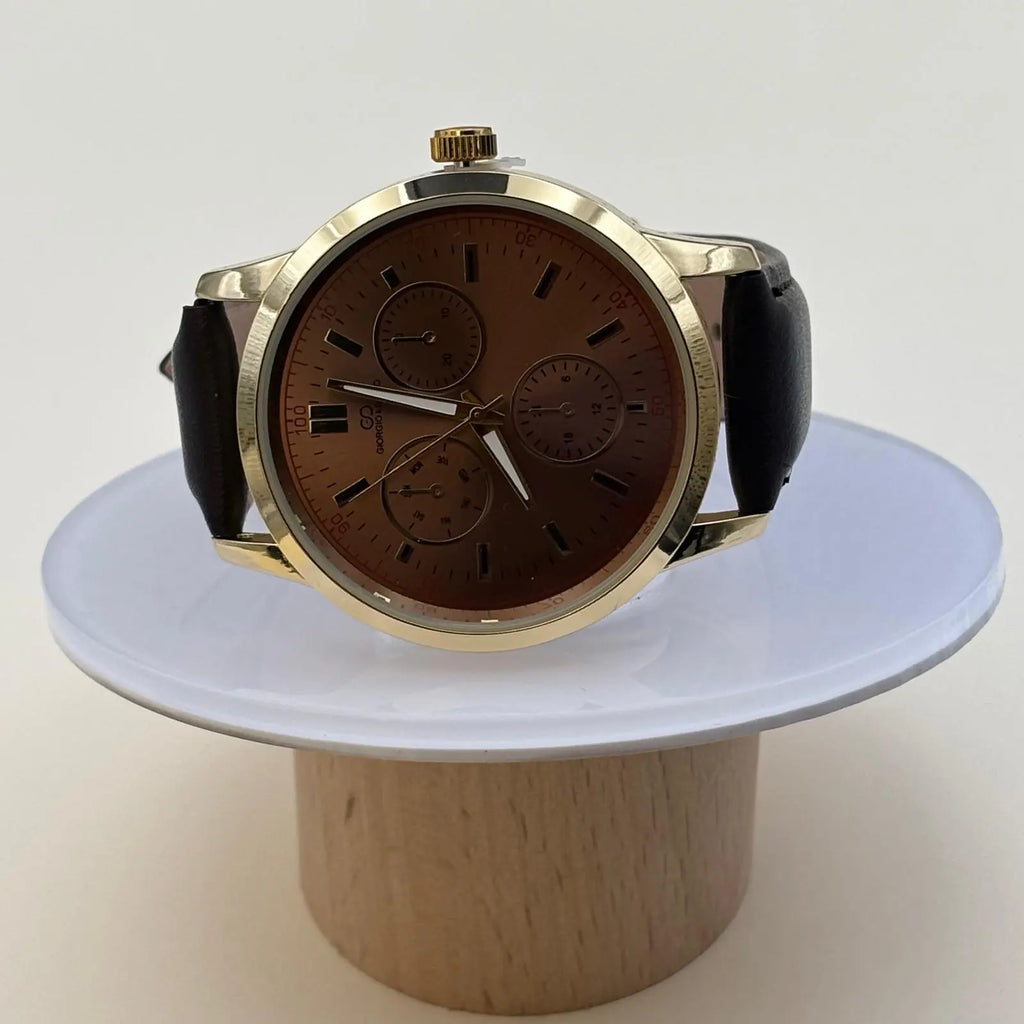 Montre pour hommes avec bracelet en simili cuir noir et cadran acier avec le fond couleur terracotta et inscriptions noires
