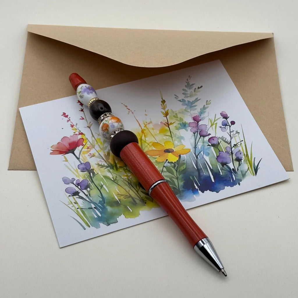 Stylo à bille à mine noire et perles colorées effet porcelaine