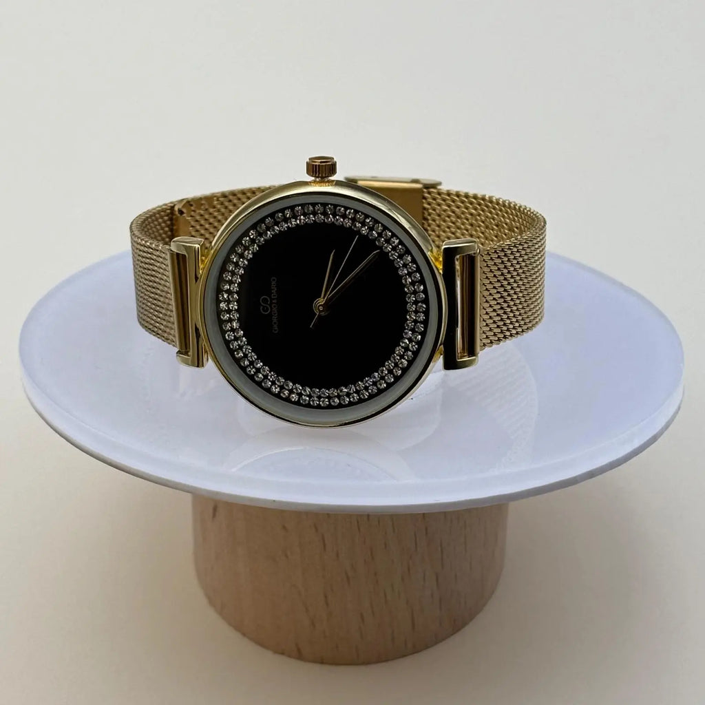 Montre pour femme bracelet doré cadran noir orné de strass sur le pourtour