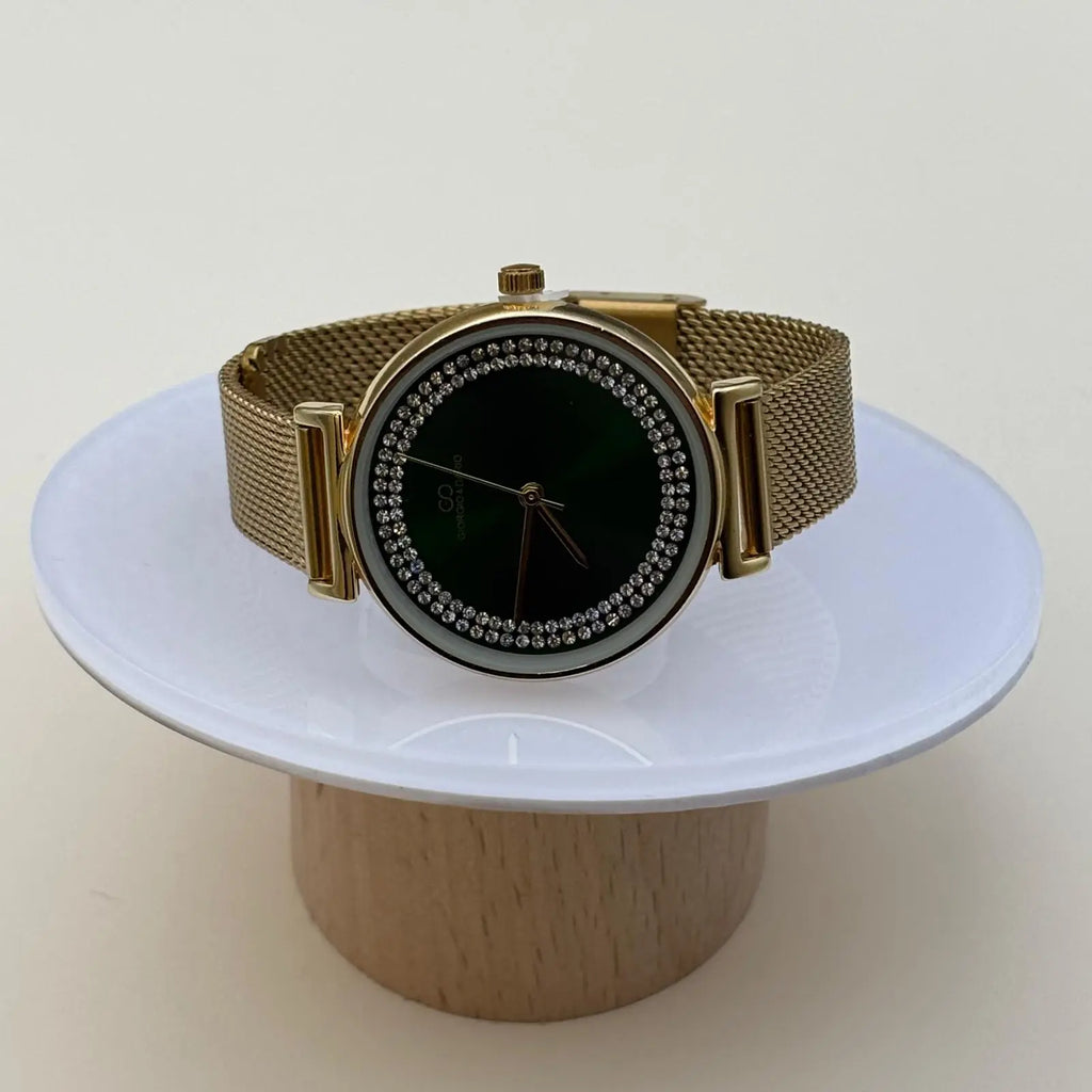 Montre pour femme bracelet doré cadran vert foncé orné de strass sur le pourtour