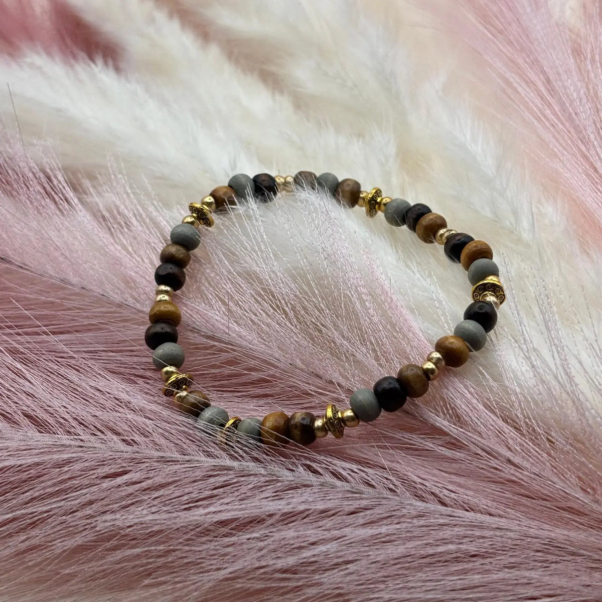 Bracelet en perles artisanal avec perles ethniques dorées et perles de bois sur élastique